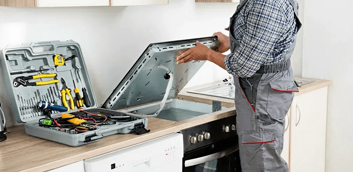 Handyman repairing a cooktop and checking wiring connections in Saint Petersburg, FL