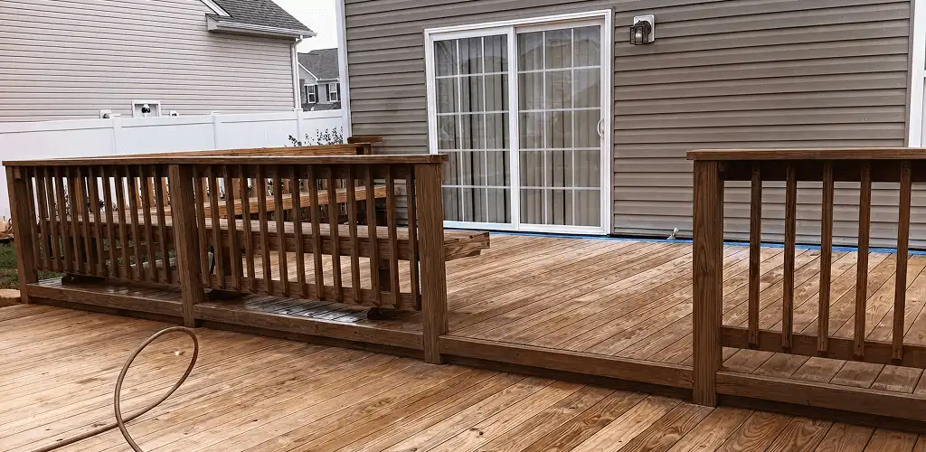 Deck sealing service protecting a backyard wood deck and railings in Saint Petersburg, FL
