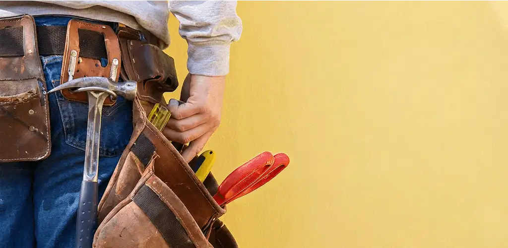 Handyman with tool belt ready for home repairs and maintenance in Saint Petersburg, FL