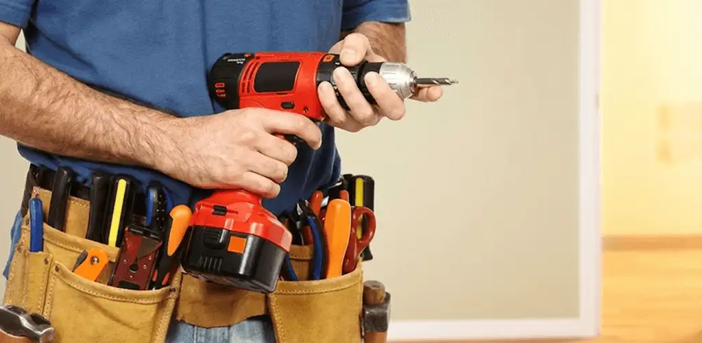Handyman holding a power drill for home repairs and installations in Saint Petersburg, FL