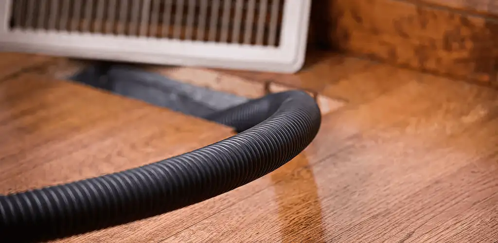Air duct cleaning hose inserted into a floor vent for ductwork cleaning in Saint Petersburg, FL